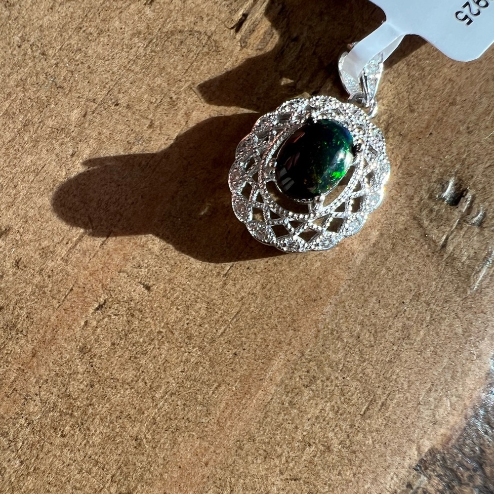 Sterling silver with a beautiful all natural black Opal pendant.
